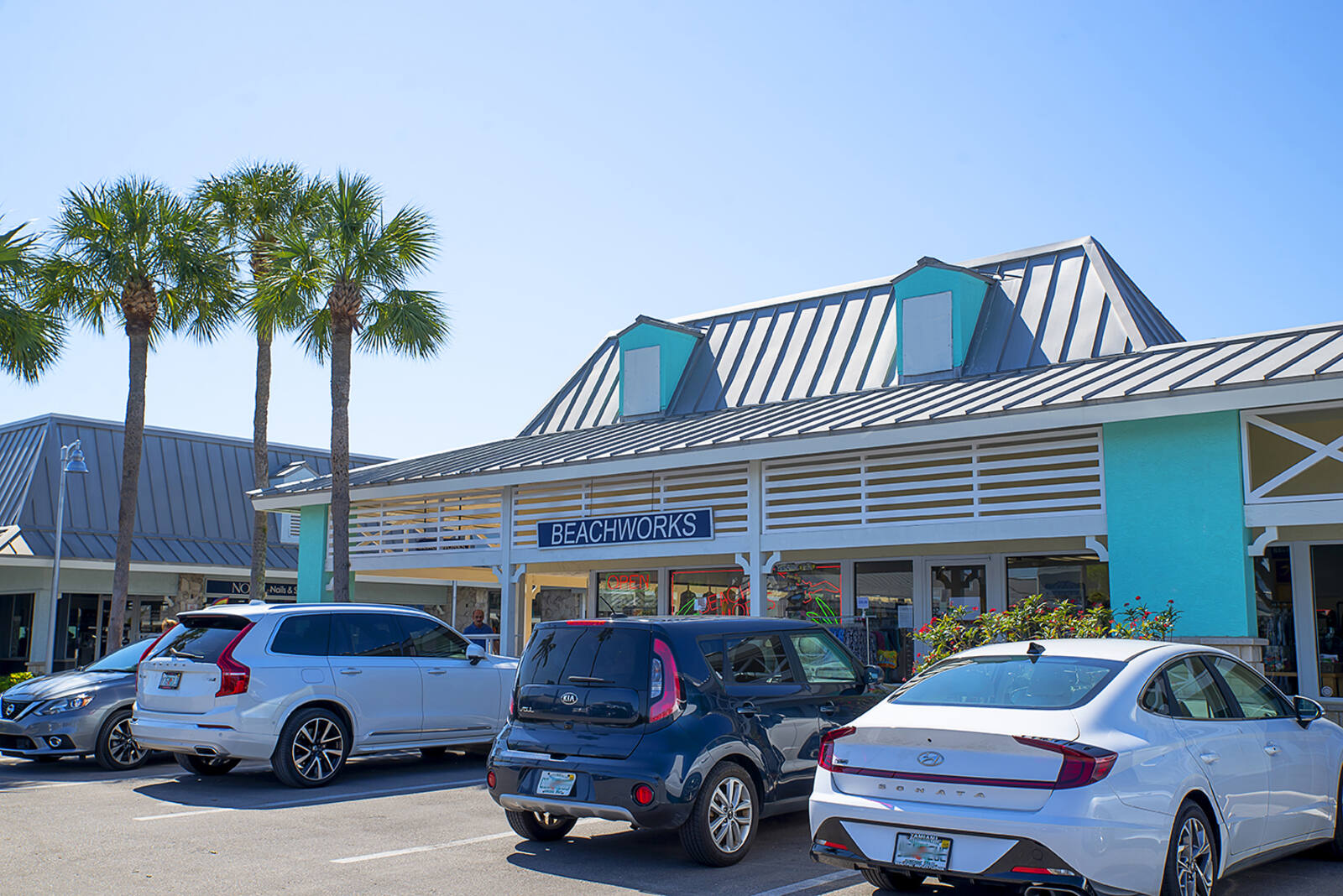 Beachworks with palm trees and parking lot in Marco Island, FL.