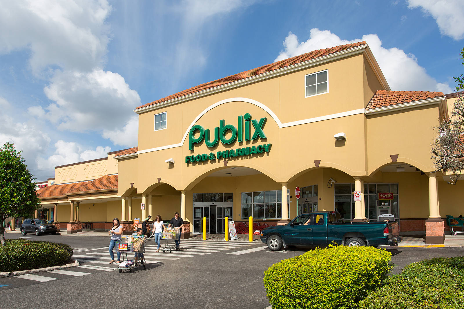 Customers with shopping carts exit Publix supermarket at Conway Crossing.