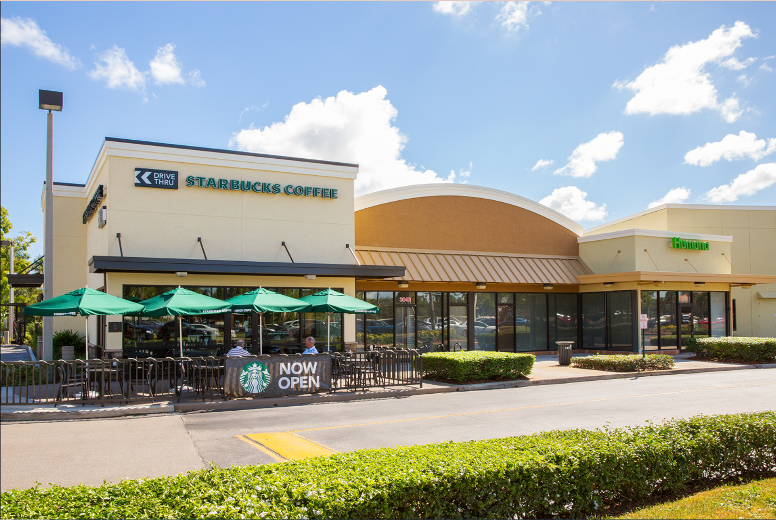 Outdoor seating and umbrellas at Starbucks Coffee.