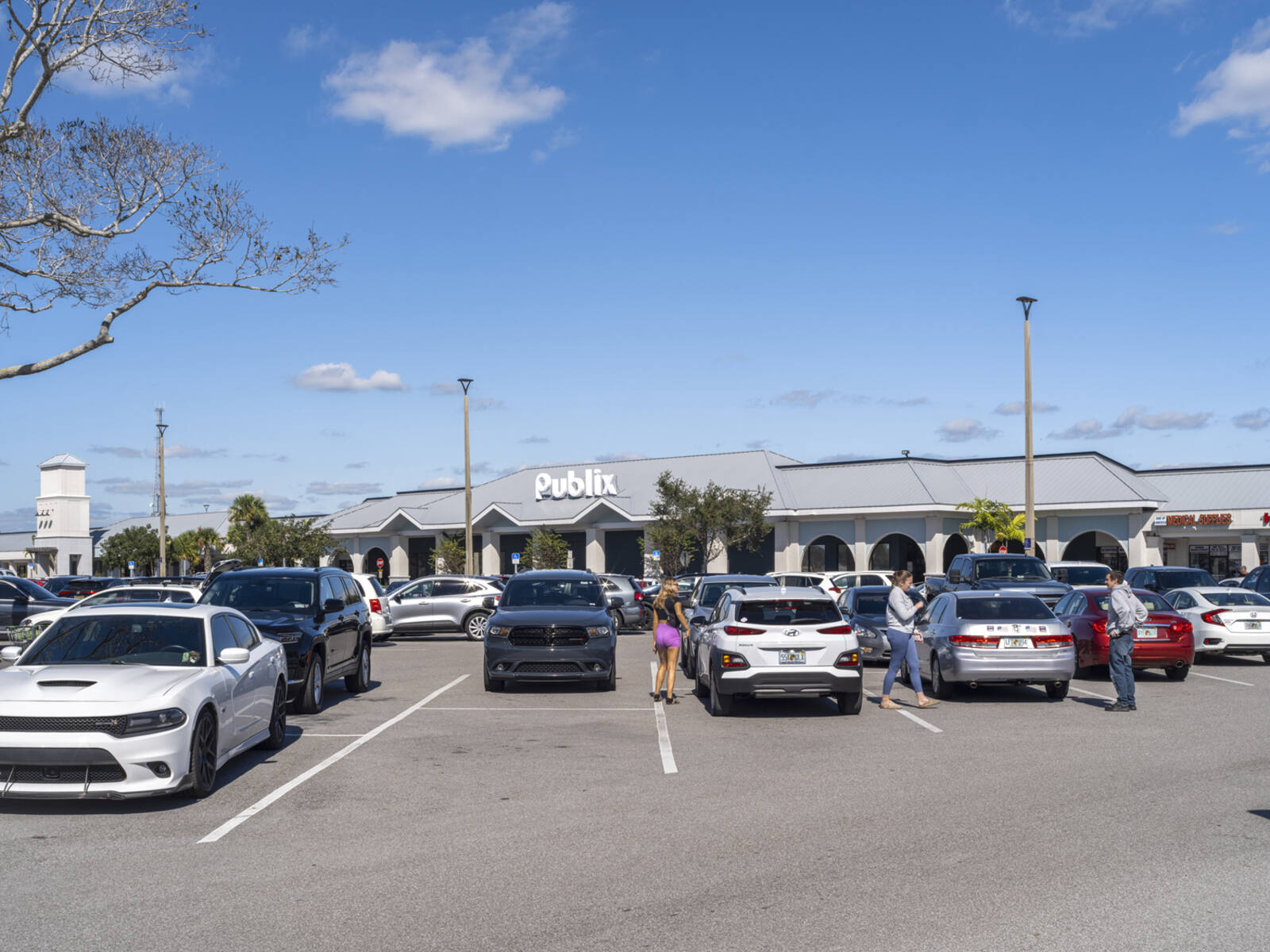 Busy parking lot with patrons in front of Publix grocer.