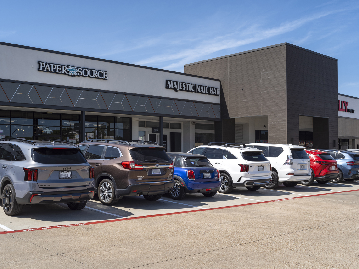Parked cars at Paper Source and Sally Beauty storefronts.