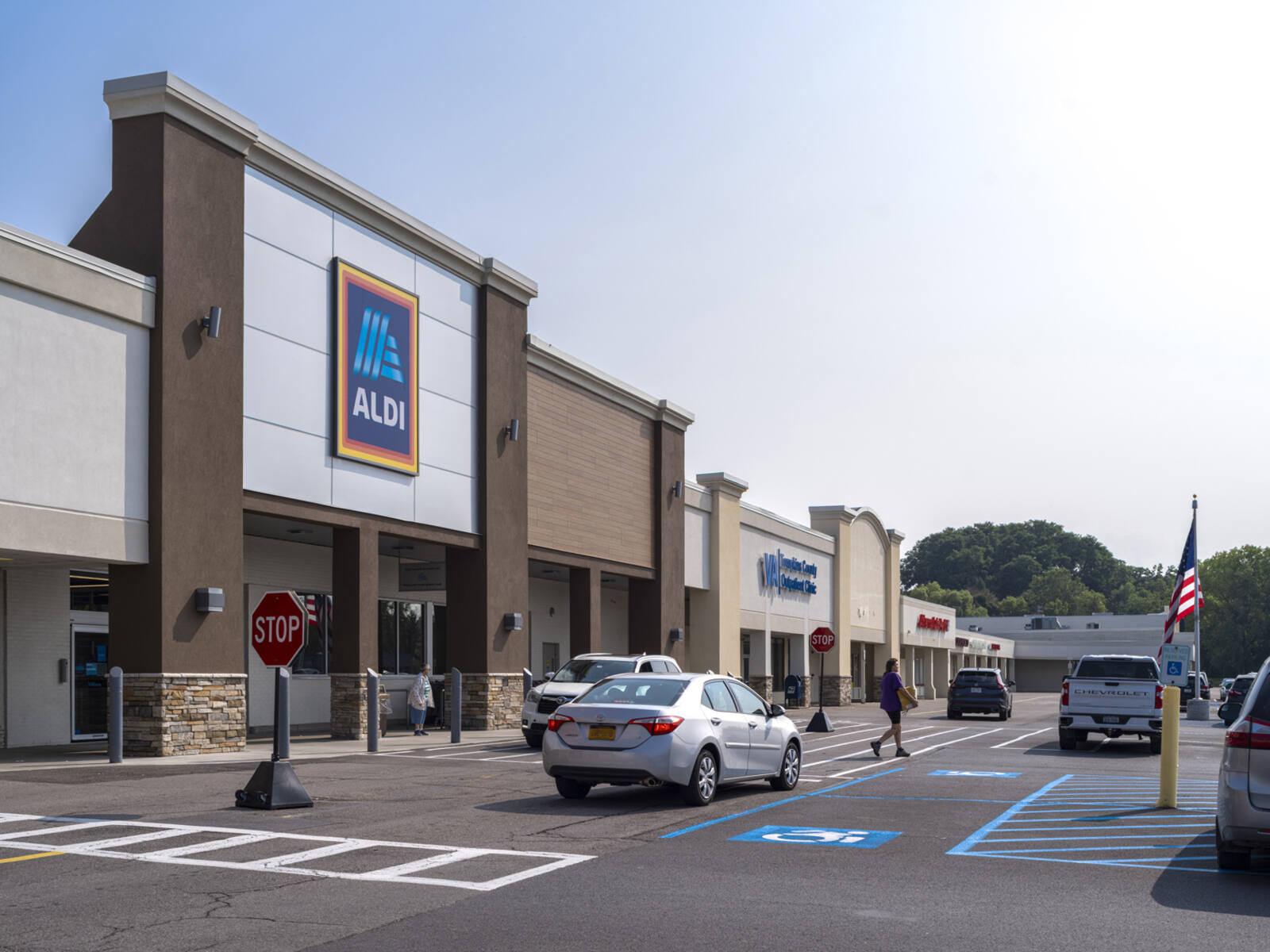 Aldi and VA Clinic with busy road at storefront.