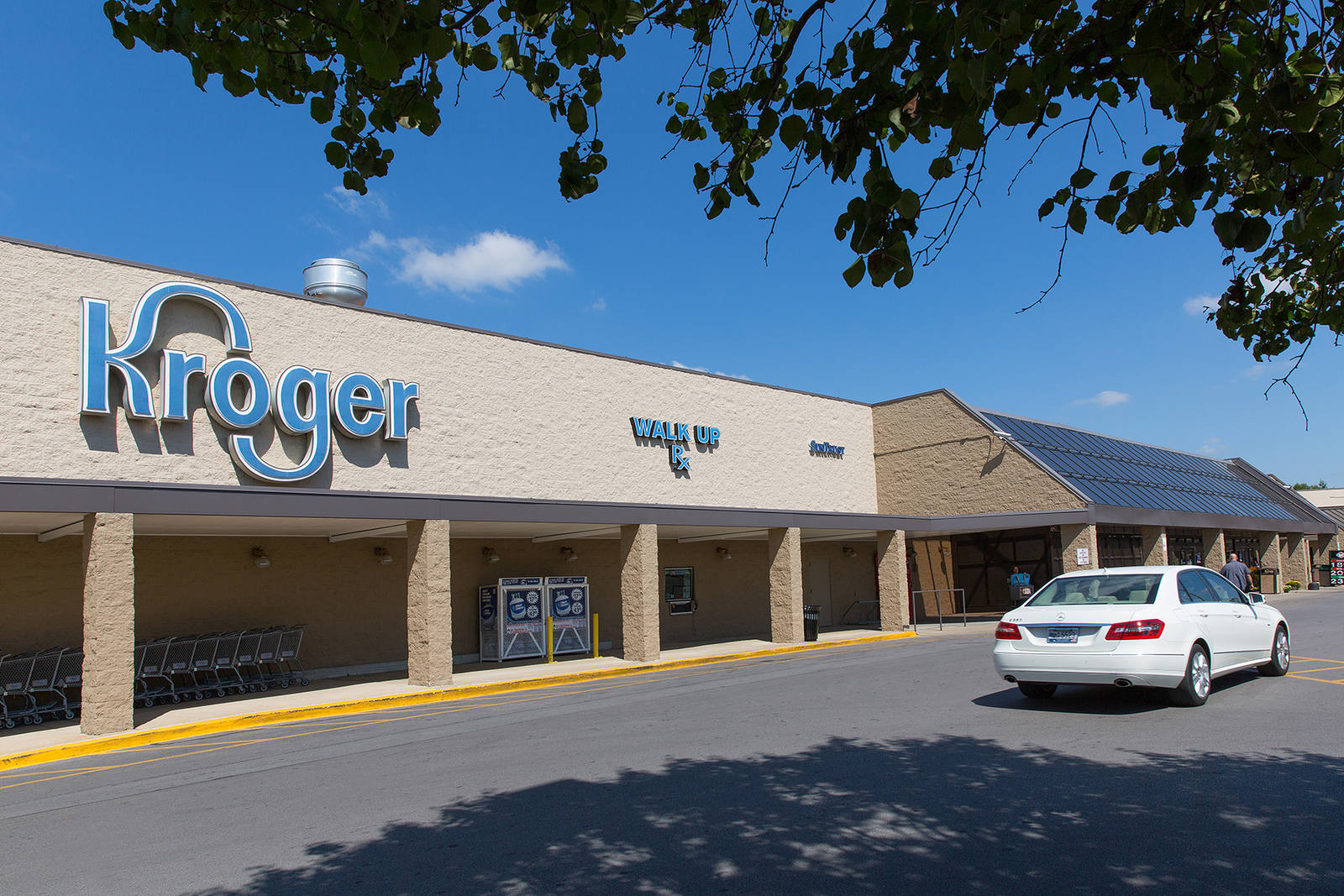 White car passing Kroger supermarket at Georgetown Square.
