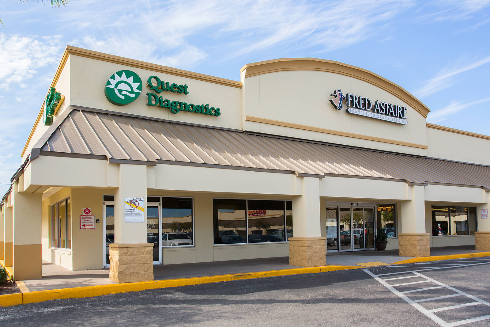 Front entrance of Quest Diagnostics at shopping center on a clear day