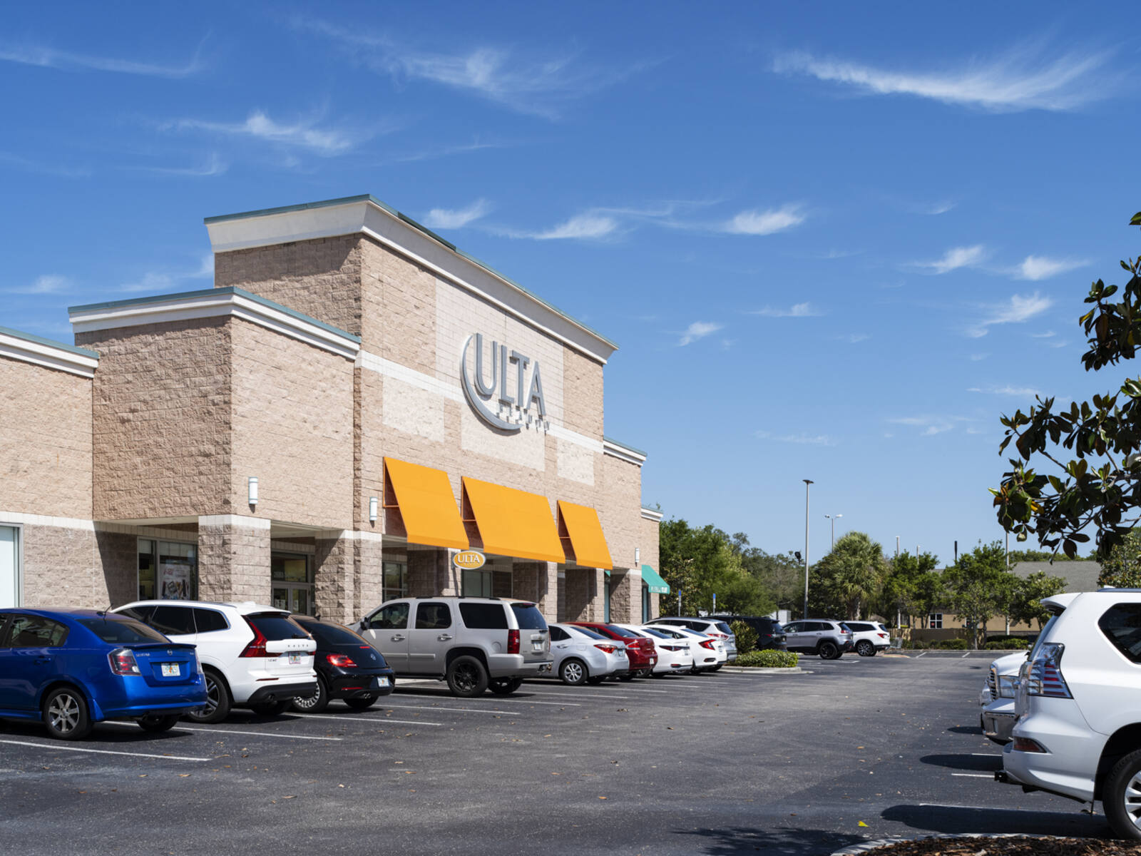 Busy tree-lined parking lot at Ulta beauty supply store at Clearwater Mall.