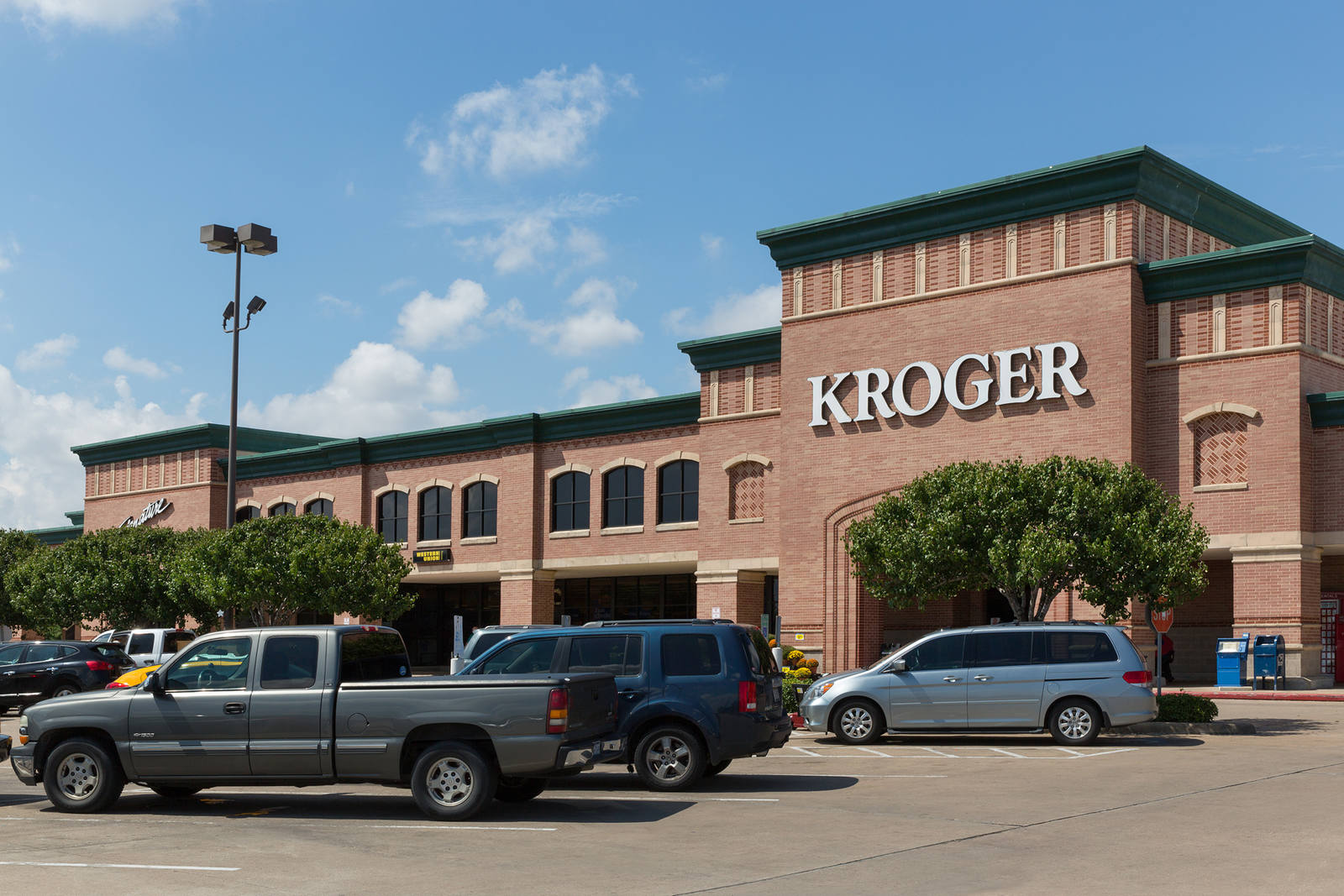 Trucks, SUVs and trees in the Kroger supermarket parking lot at Crossroads Centre in Pasadena, TX.