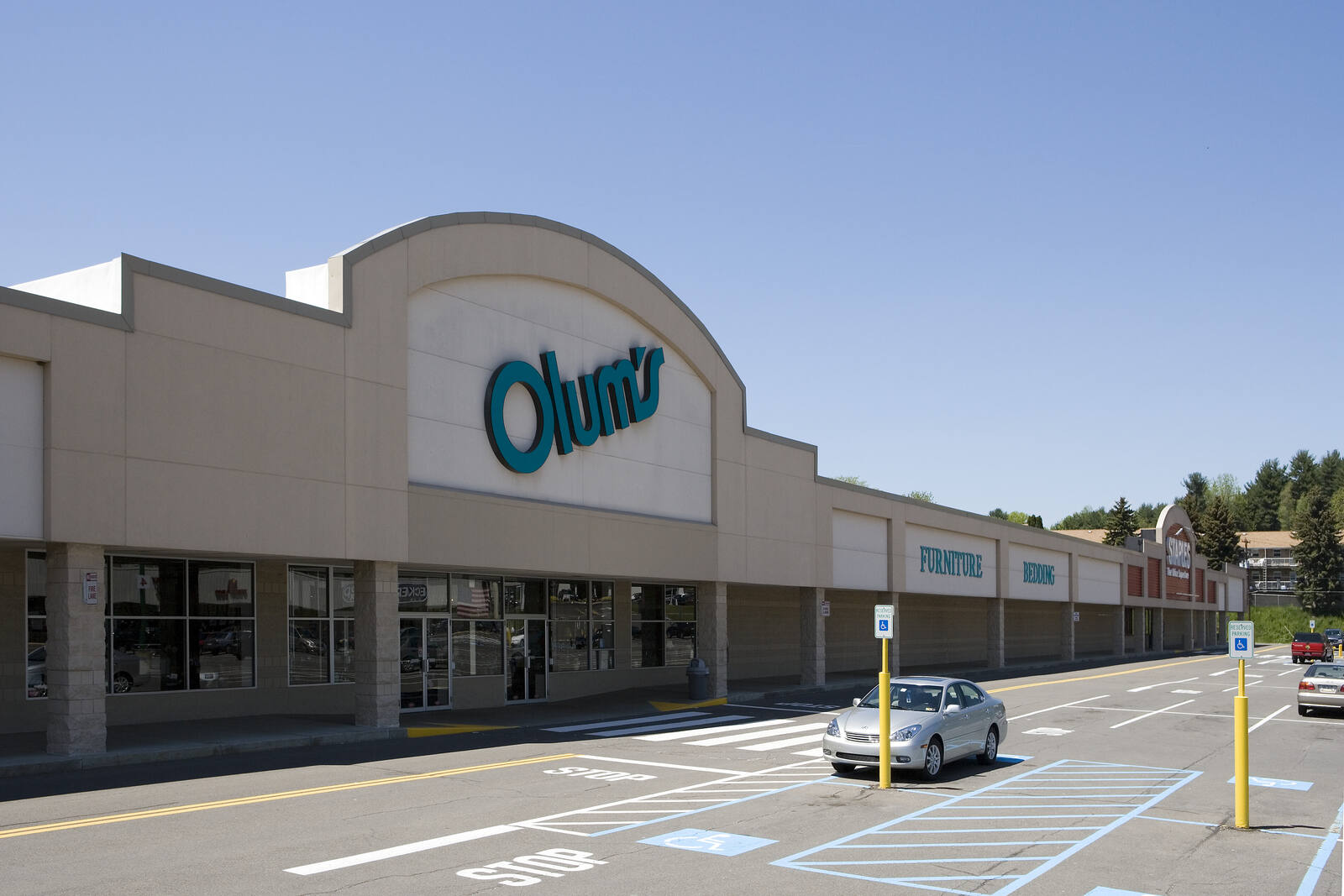 Grey car in front of Olum's parking lot in Vestal, NY.