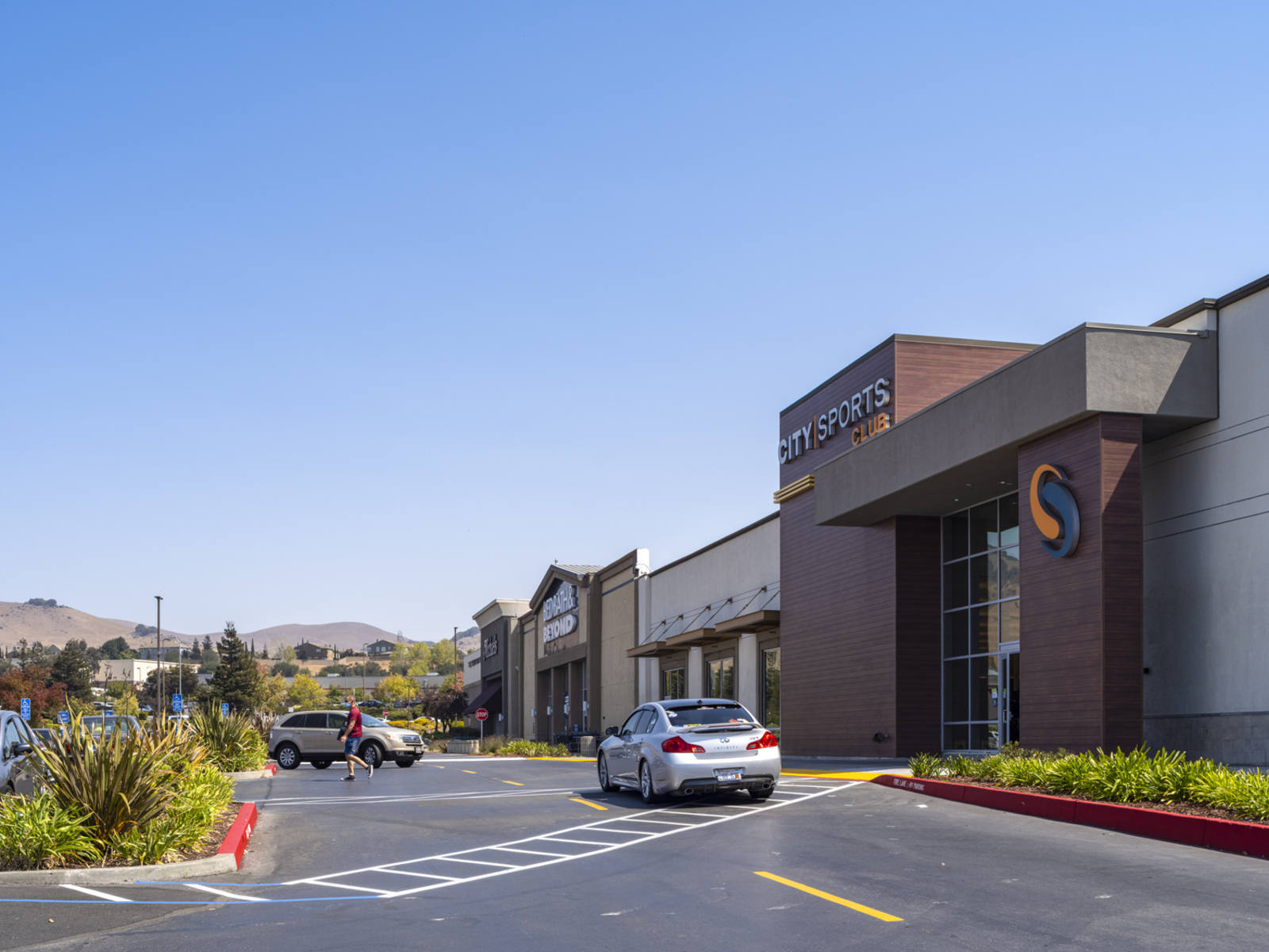 City Sports with cars pulled in front by planters at Gateway Plaza.