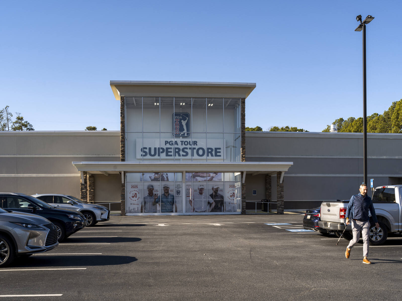 Man leaving parking lot at PGA Tour Superstore.