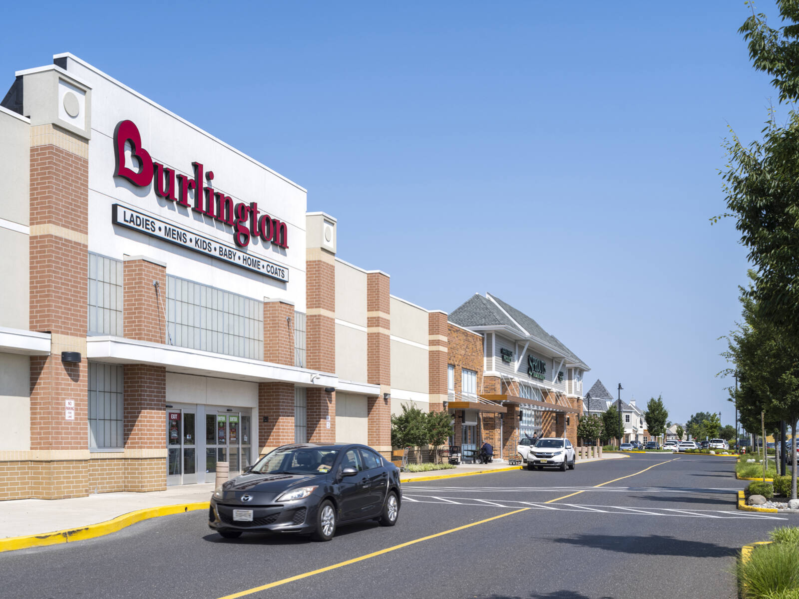 Cars passing road in front of Burlington at Marlton Crossing.
