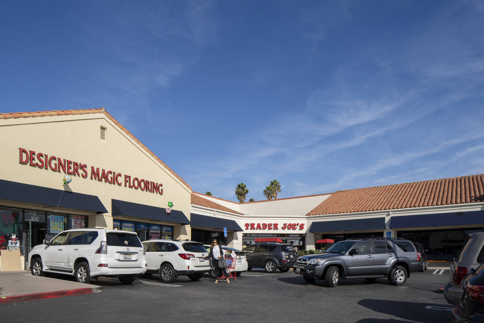 Person walking through full parking lot of Trader Joe's