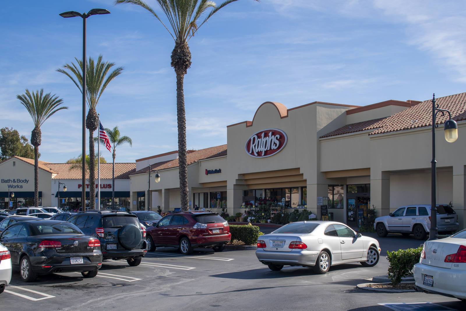 Palm tree lined parking lot of Ralphs at Ocean View Plaza shopping center