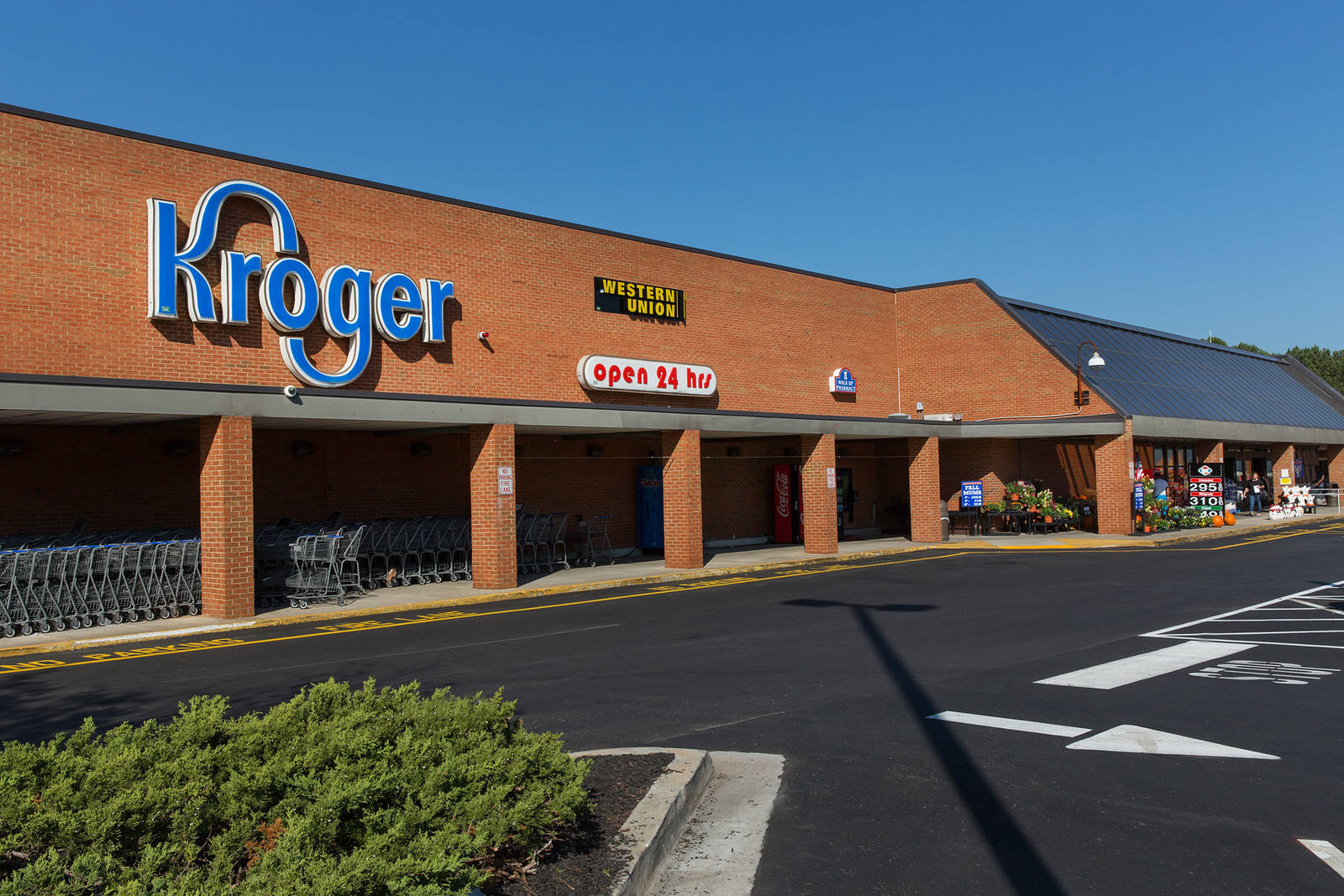 Shopping carts lining entrance of Kroger exterior