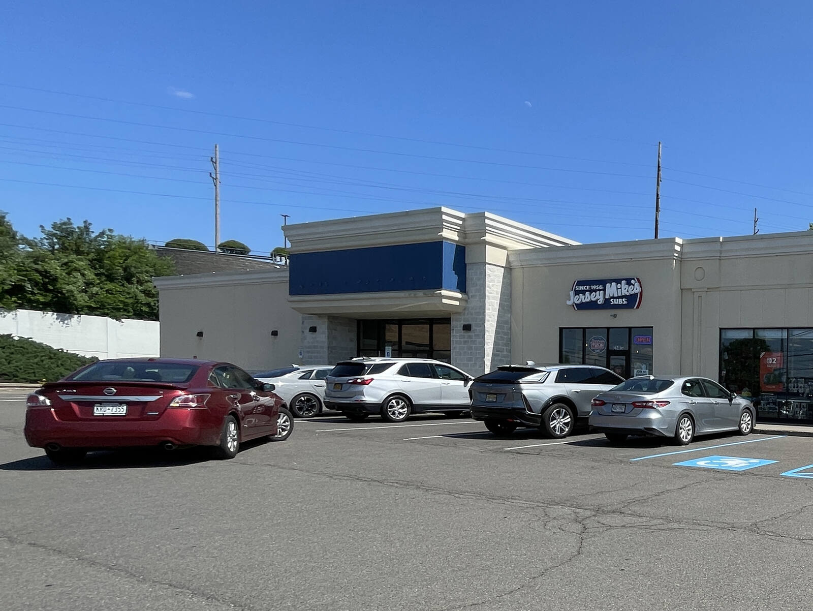 A red sedan pulls up to Vestal Exchange