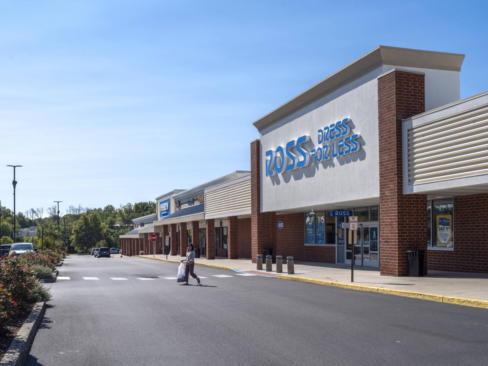 Woman with bag in crosswalk for Ross Dress for Less.