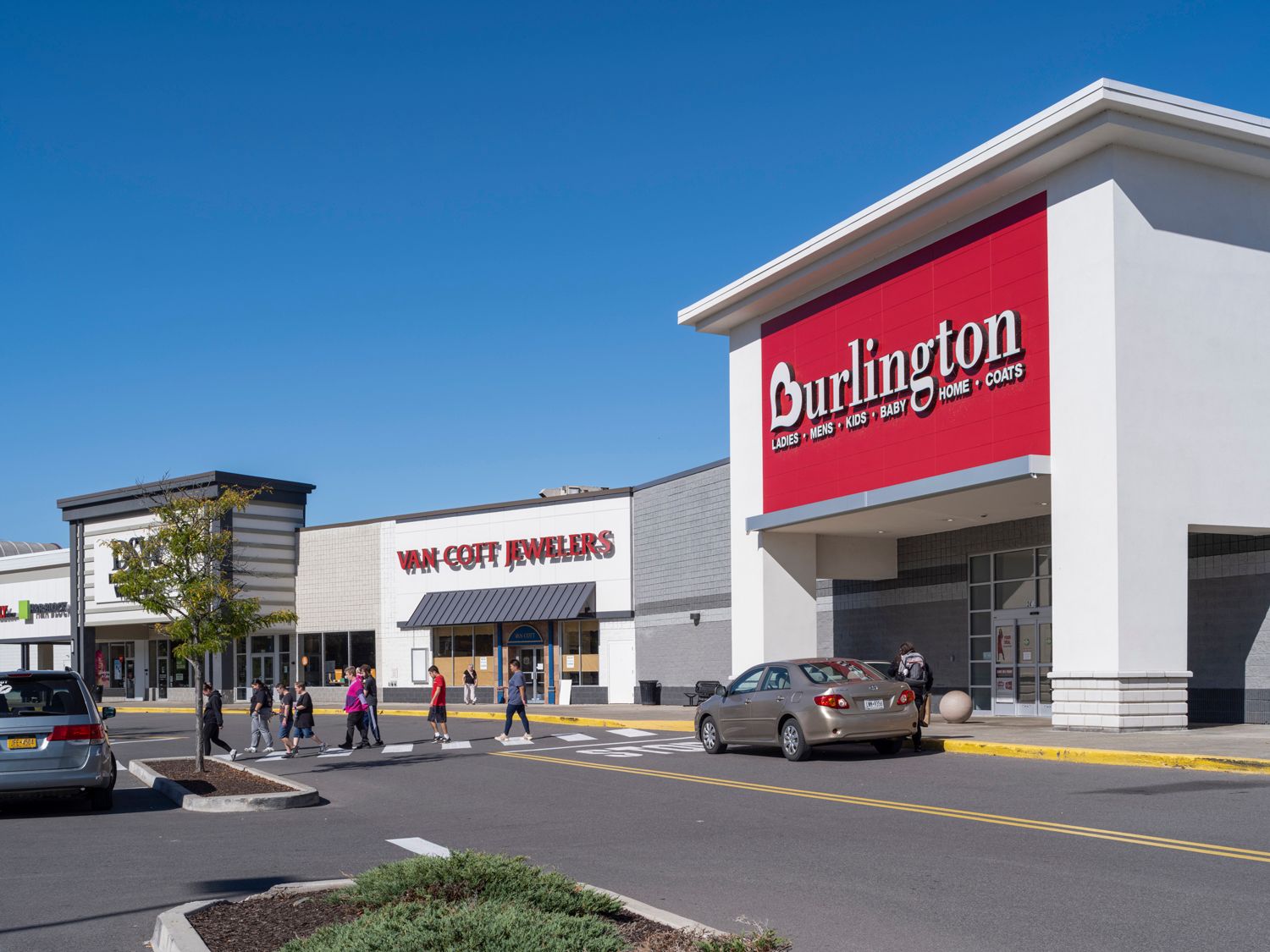 Burlington storefront with customers crossing street in front.