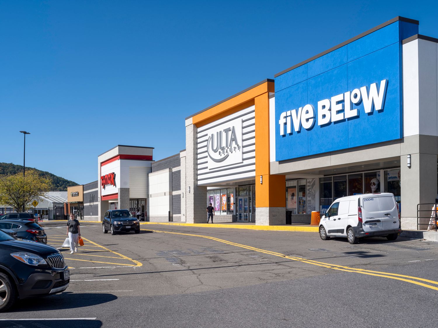 Five Below and Ulta stores with parking lot and customers on access road.