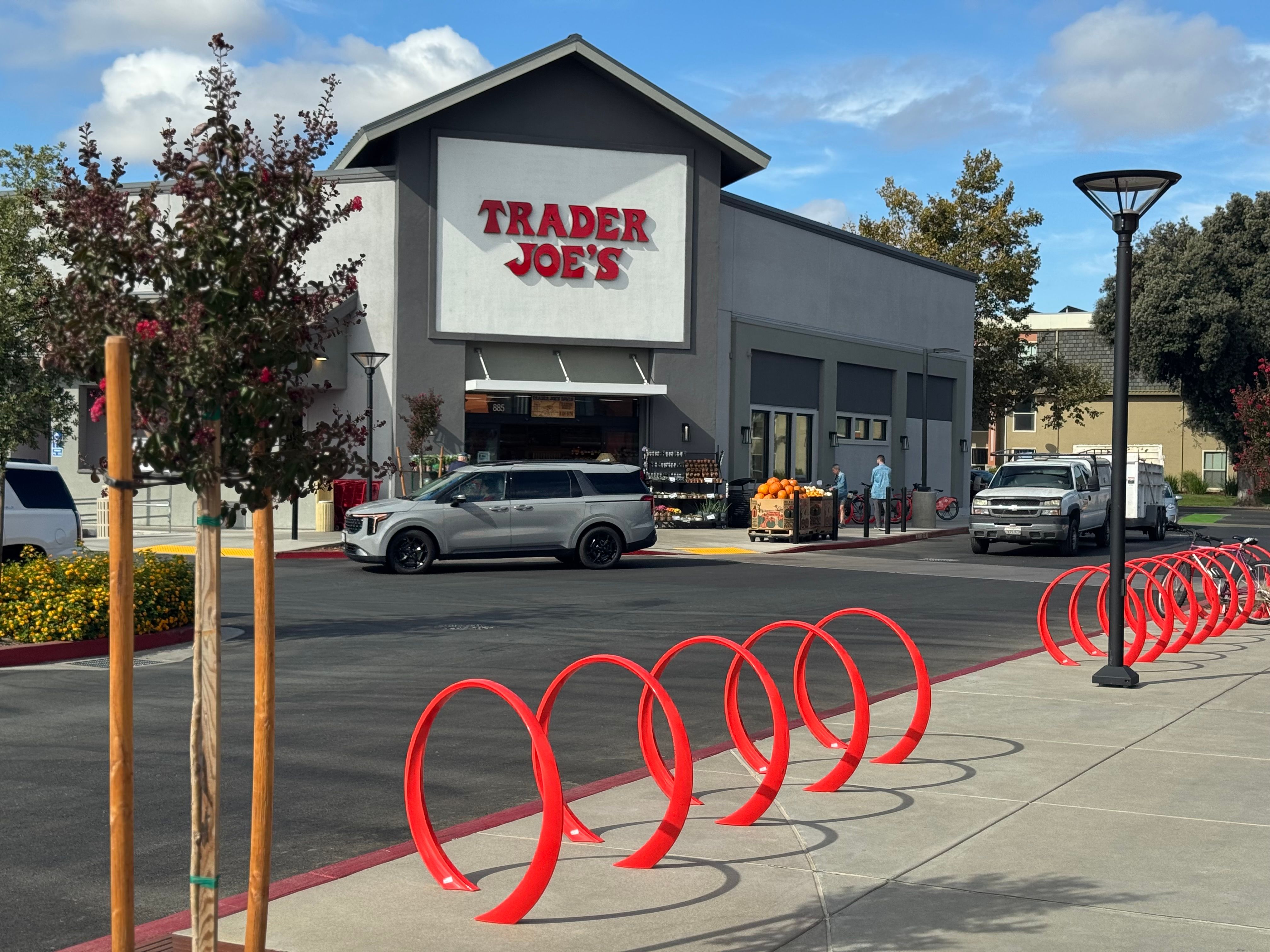 Grey car passing in front of The Davis Collection in Davis, CA