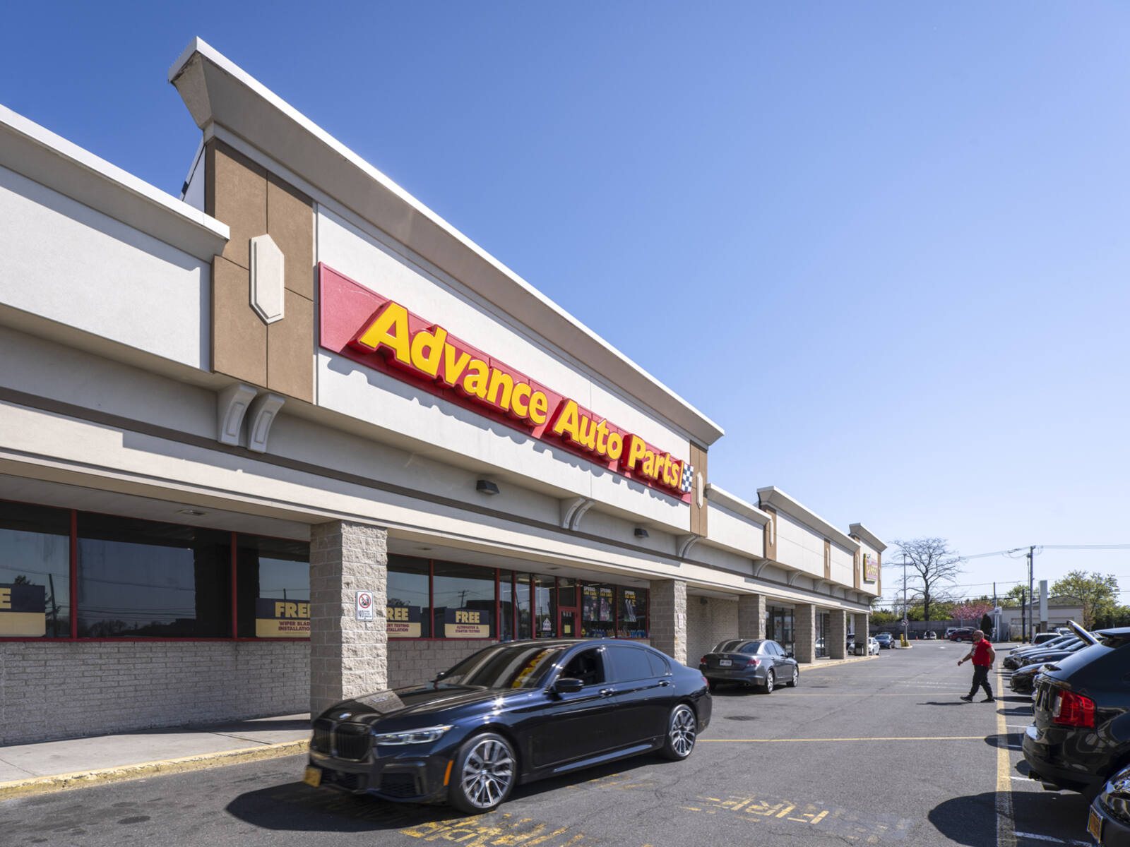 Black sedan passing Advance Auto Parts in Lawrence, NY.