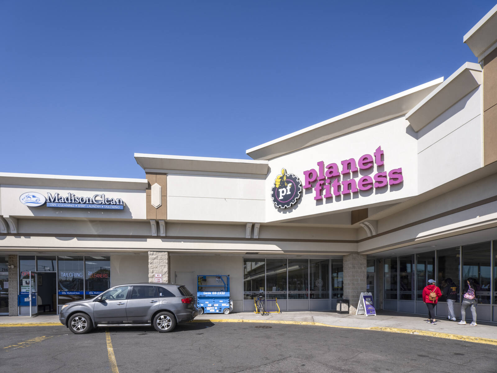 Grey SUV pulls up to Planet Fitness at Falcaro's Plaza.