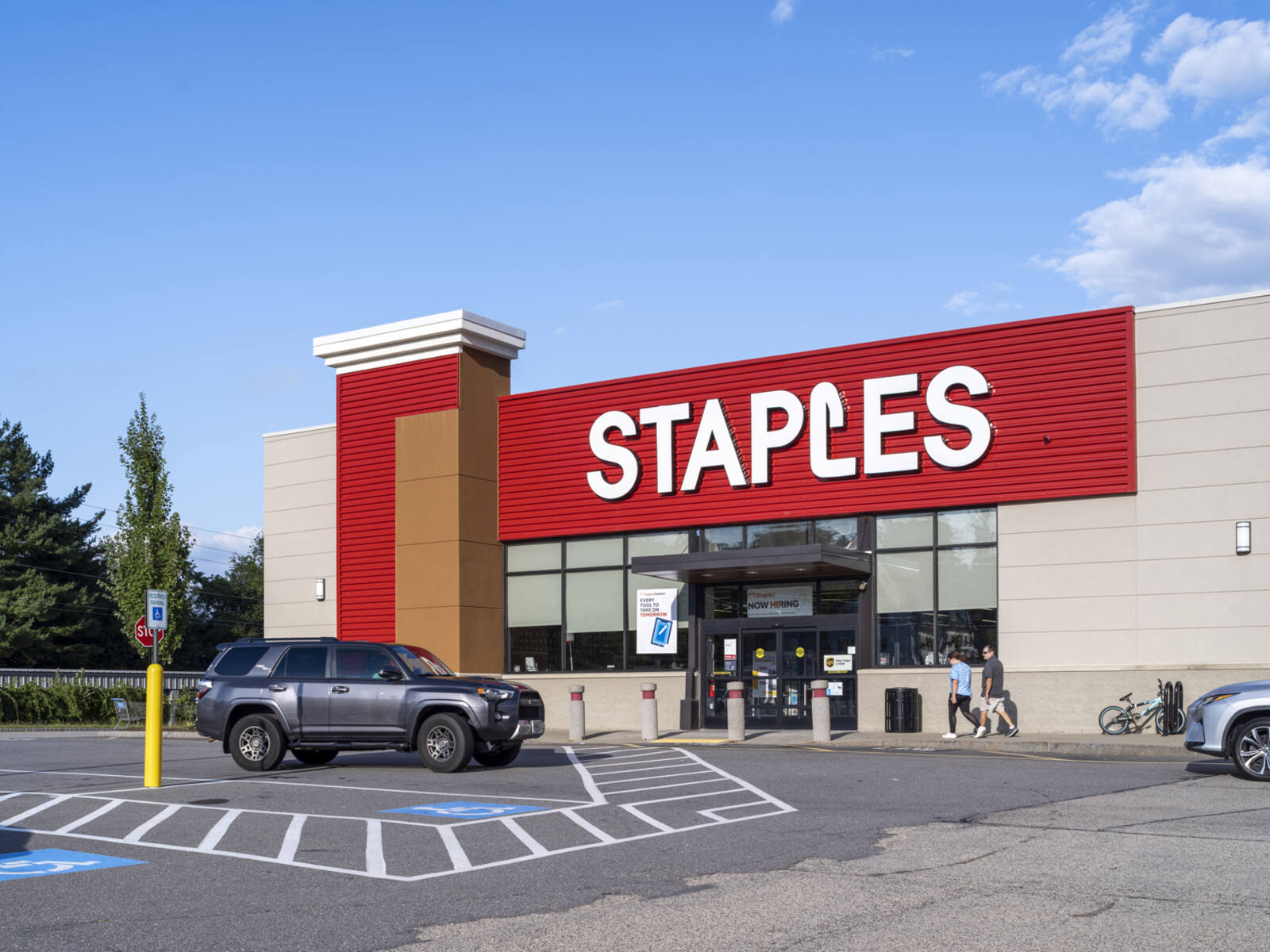 Grey SUV pulls up to Staples office supply store.