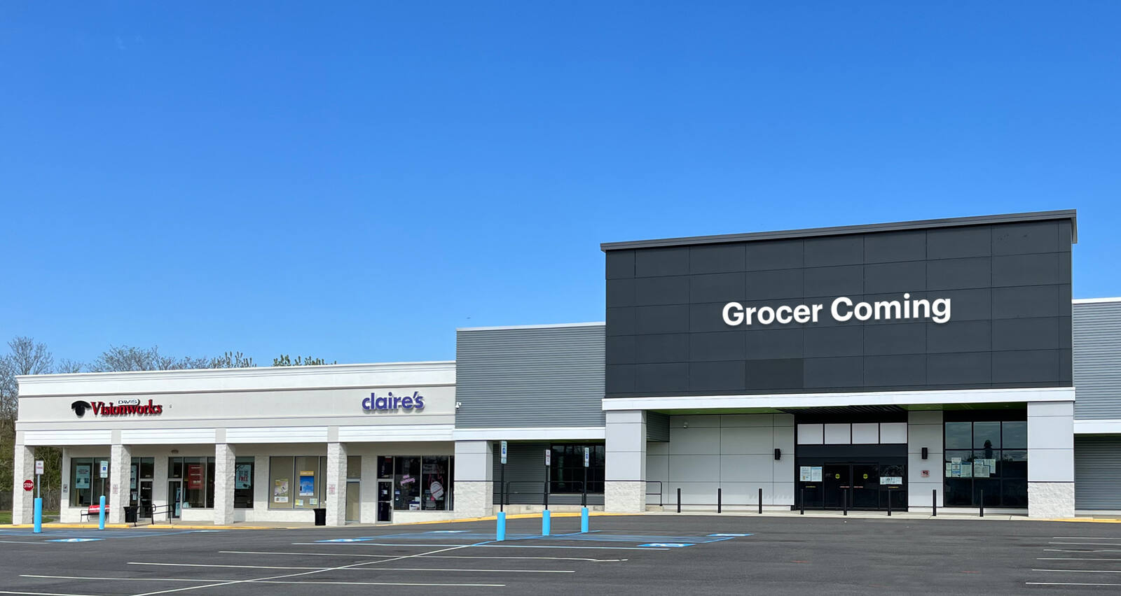 Blue sky with shopping center shops and big box store with Grocer Coming label.