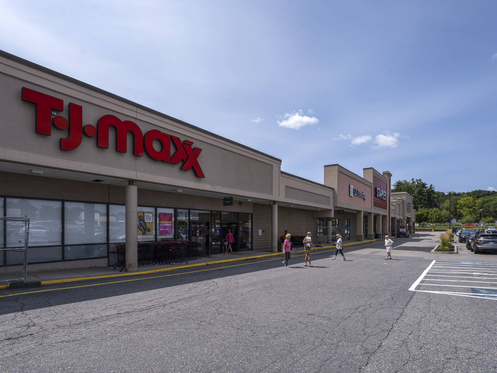 Patrons in a crosswalk in front of TJ Maxx.