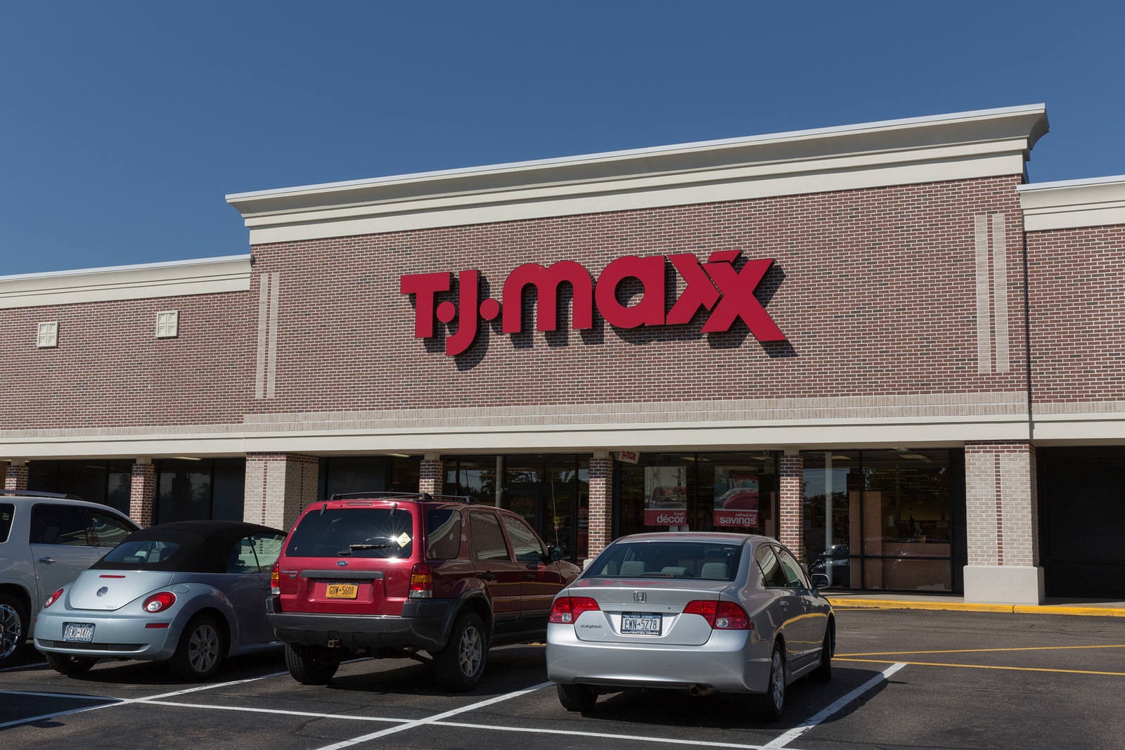 TJ Maxx department store and cars in parking lot in Kings Park, NY.