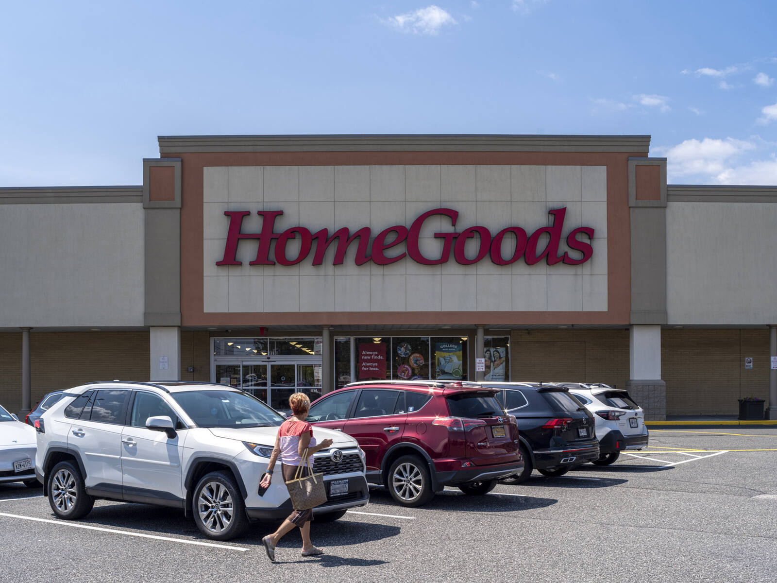 HomeGoods with patron and parked cars in front of it.