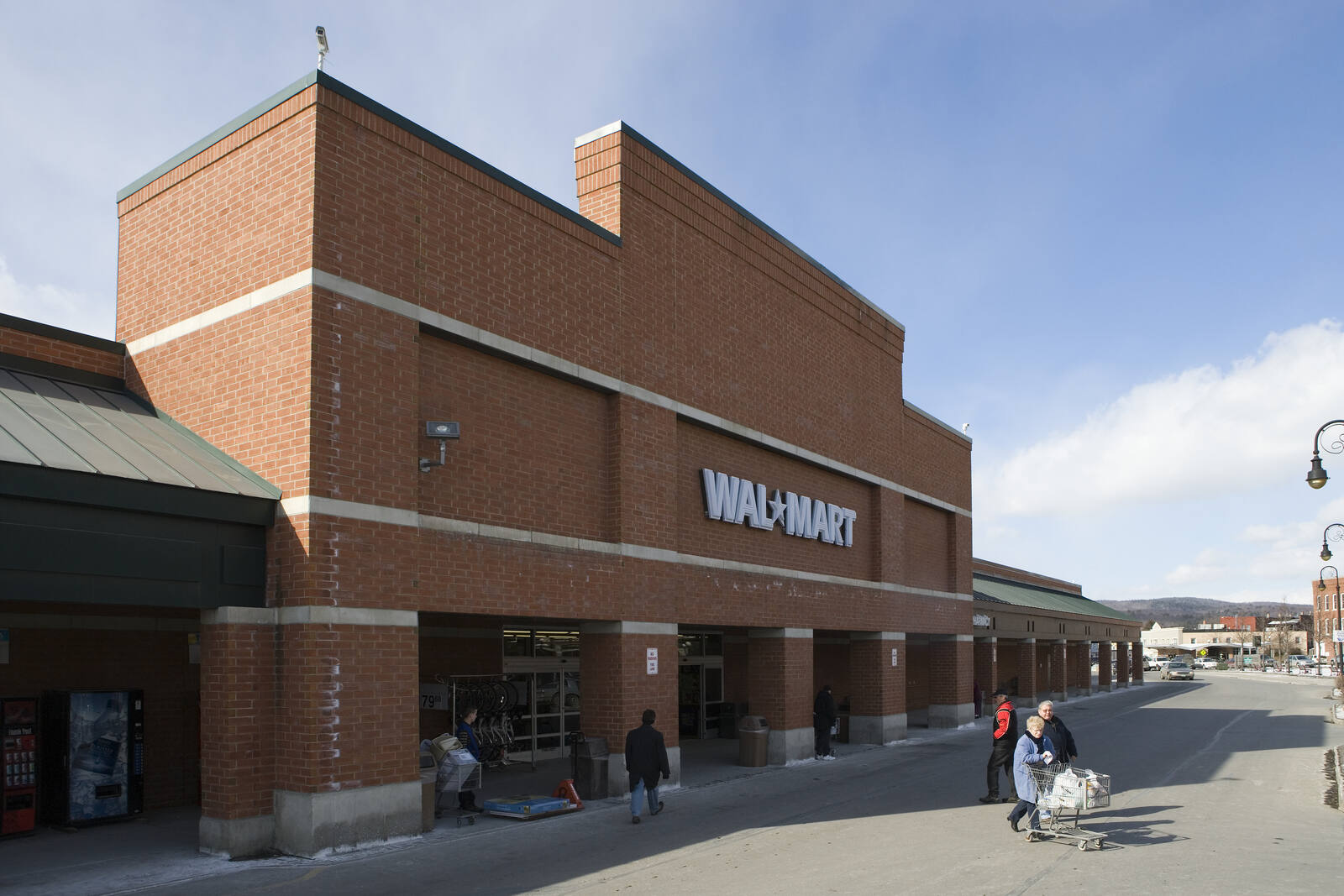 People walking through parking lot outside of Wal-Mart