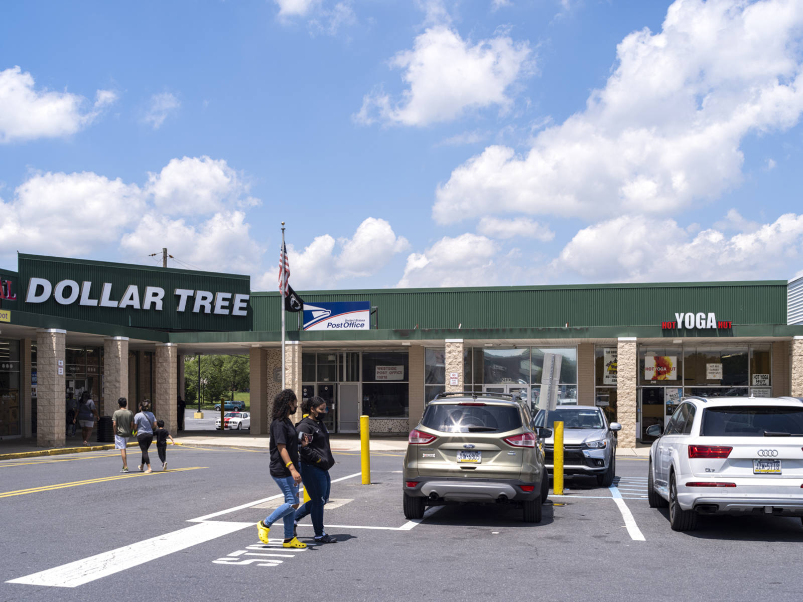 Pedestrians in parking lot for Dollar Tree in Bethlehem, PA.
