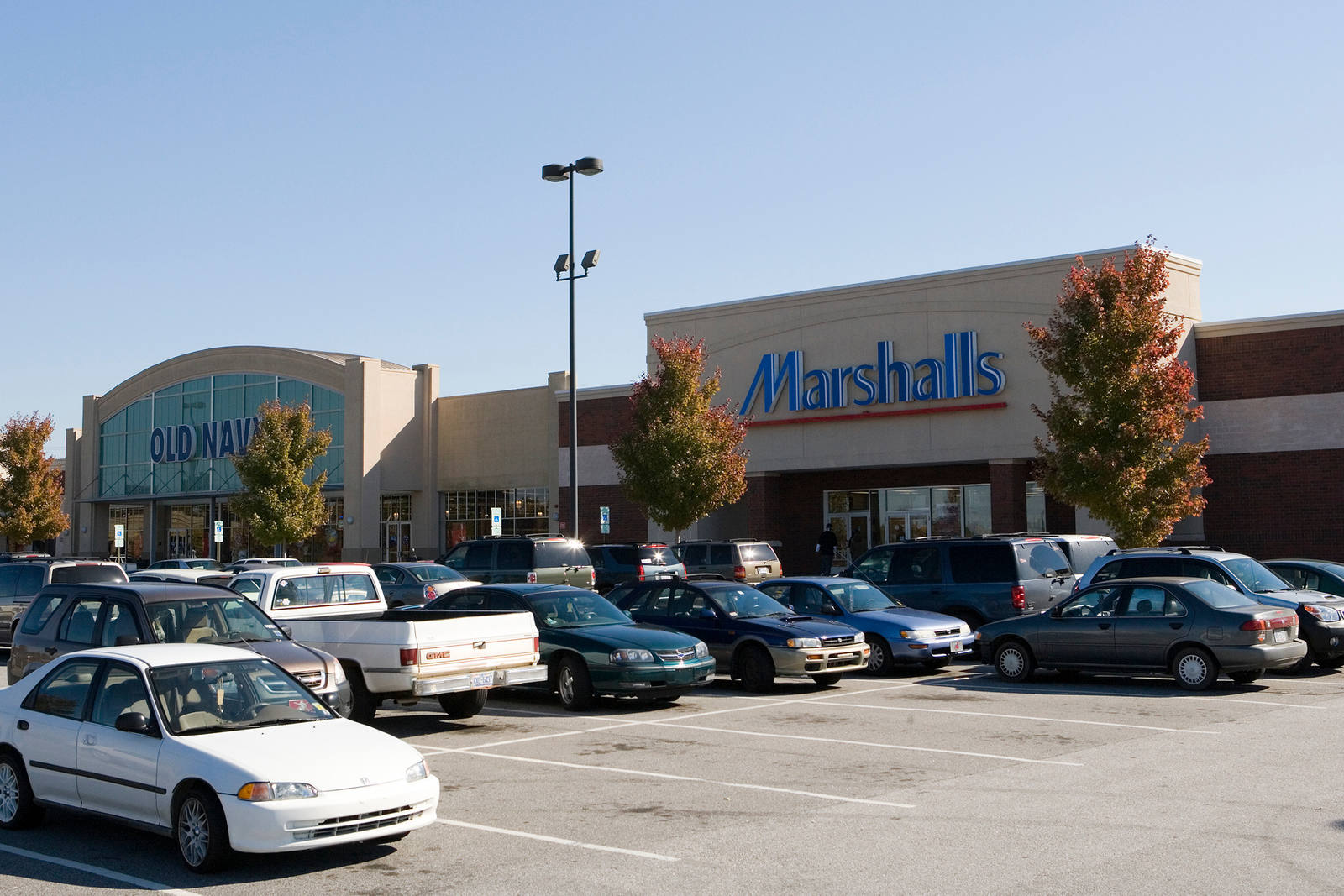 Busy parking lot with trees in front of Marshalls and Old Navy at Innes Street Market.