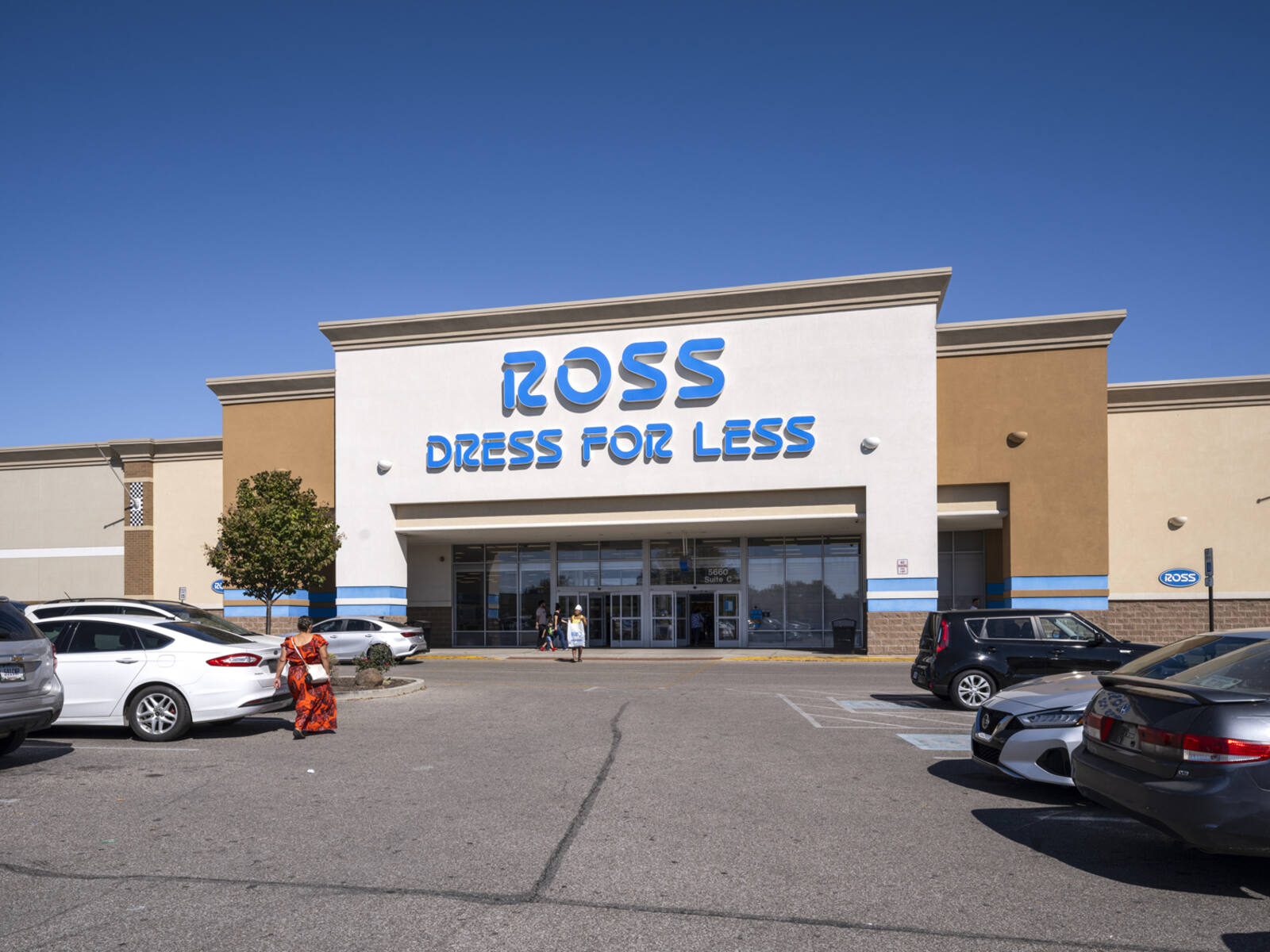 Customers enter and exit Ross Dress for Less into a parking lot.
