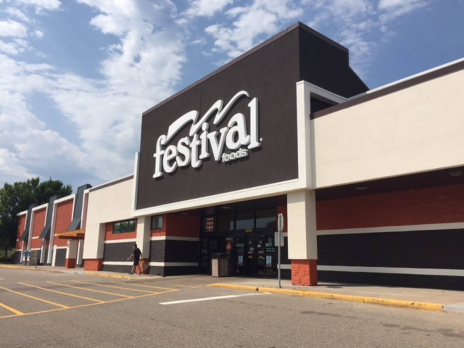 Customer in front of Festival Foods grocery store in White Bear Lake, MN.