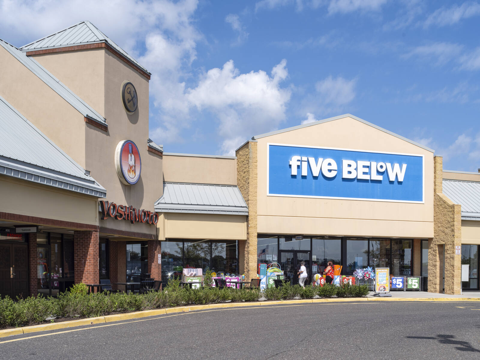 Planters, outdoor seating and customers entering Five Below retailer in Turnersville, NJ.