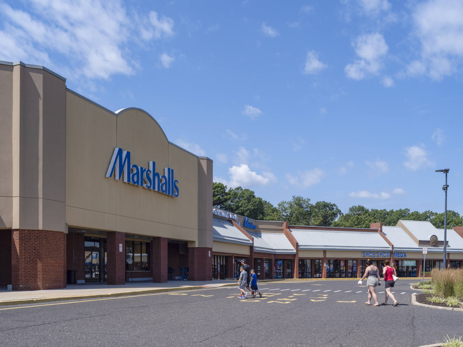 Customers in crosswalk walking towards Marshalls at Cross Keys Commons.