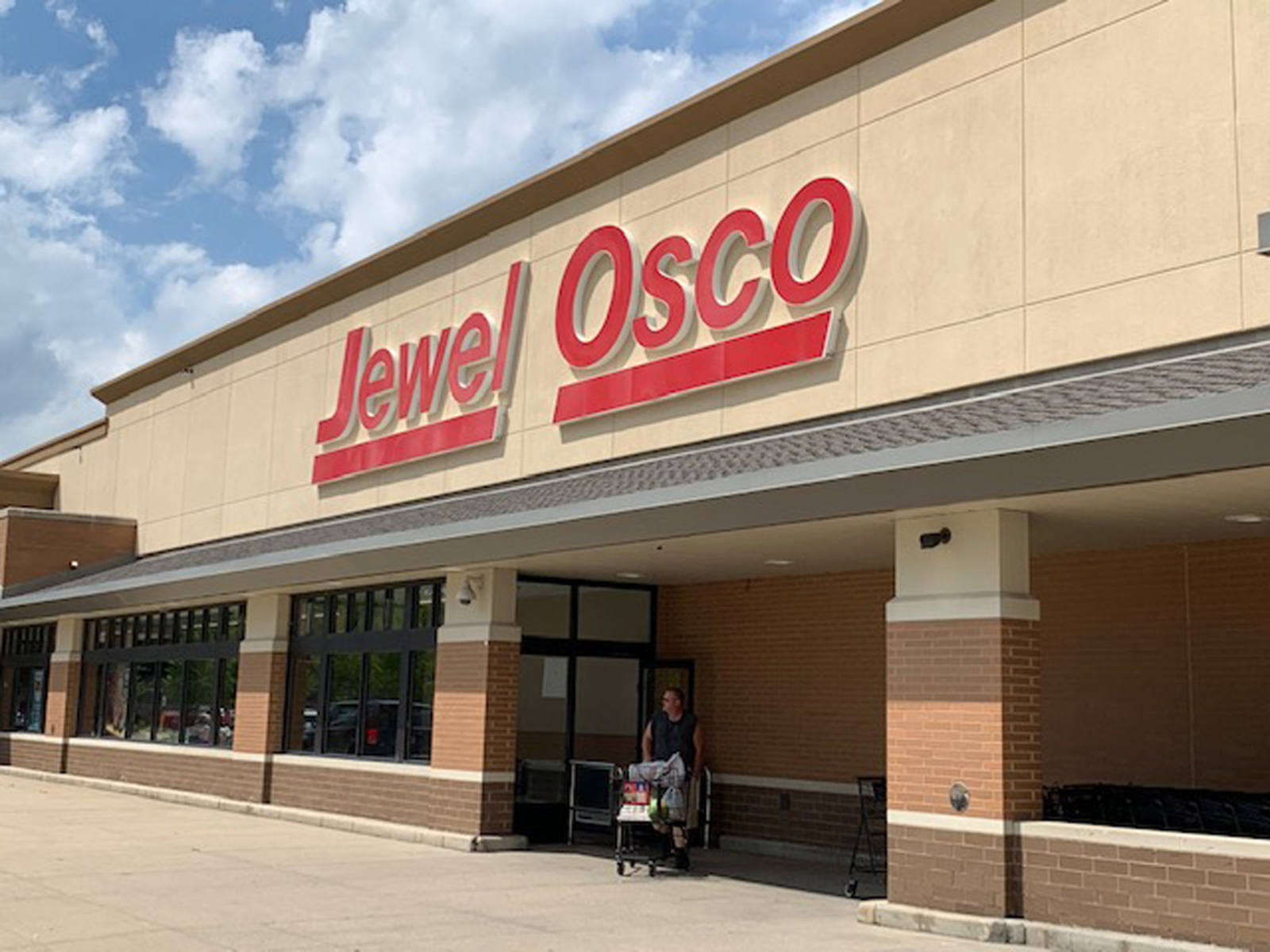 Man with cart exiting Jewel Osco supermarket at Long Meadow Commons.