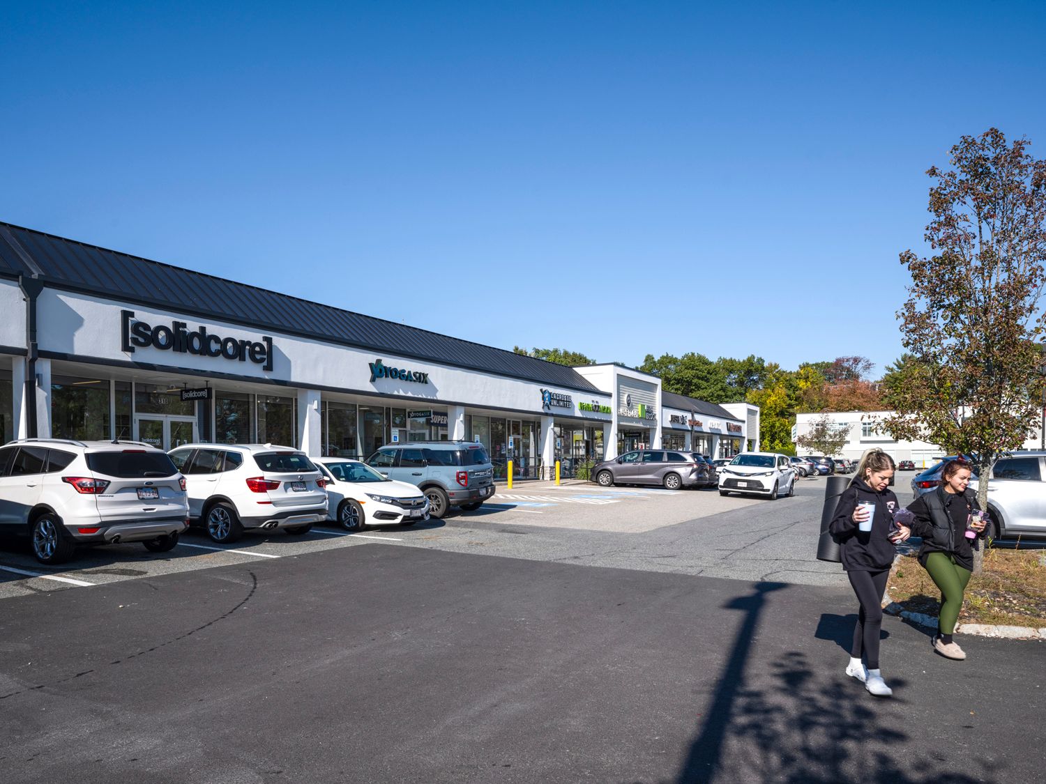 Busy parking lot with two women exiting solidcore.