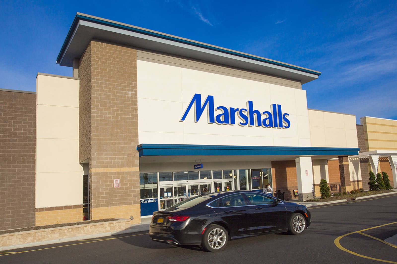 Black car passing by entrance of Marshalls at The Shops at Riverhead