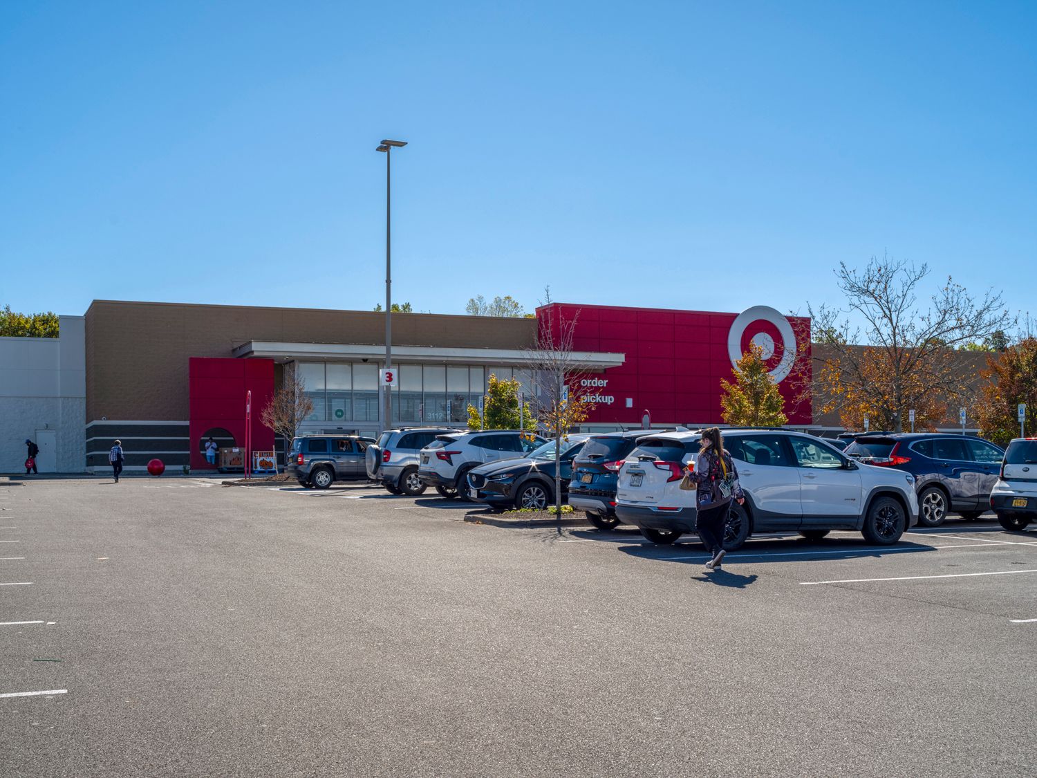 Target with busy parking lot and tree on the right.