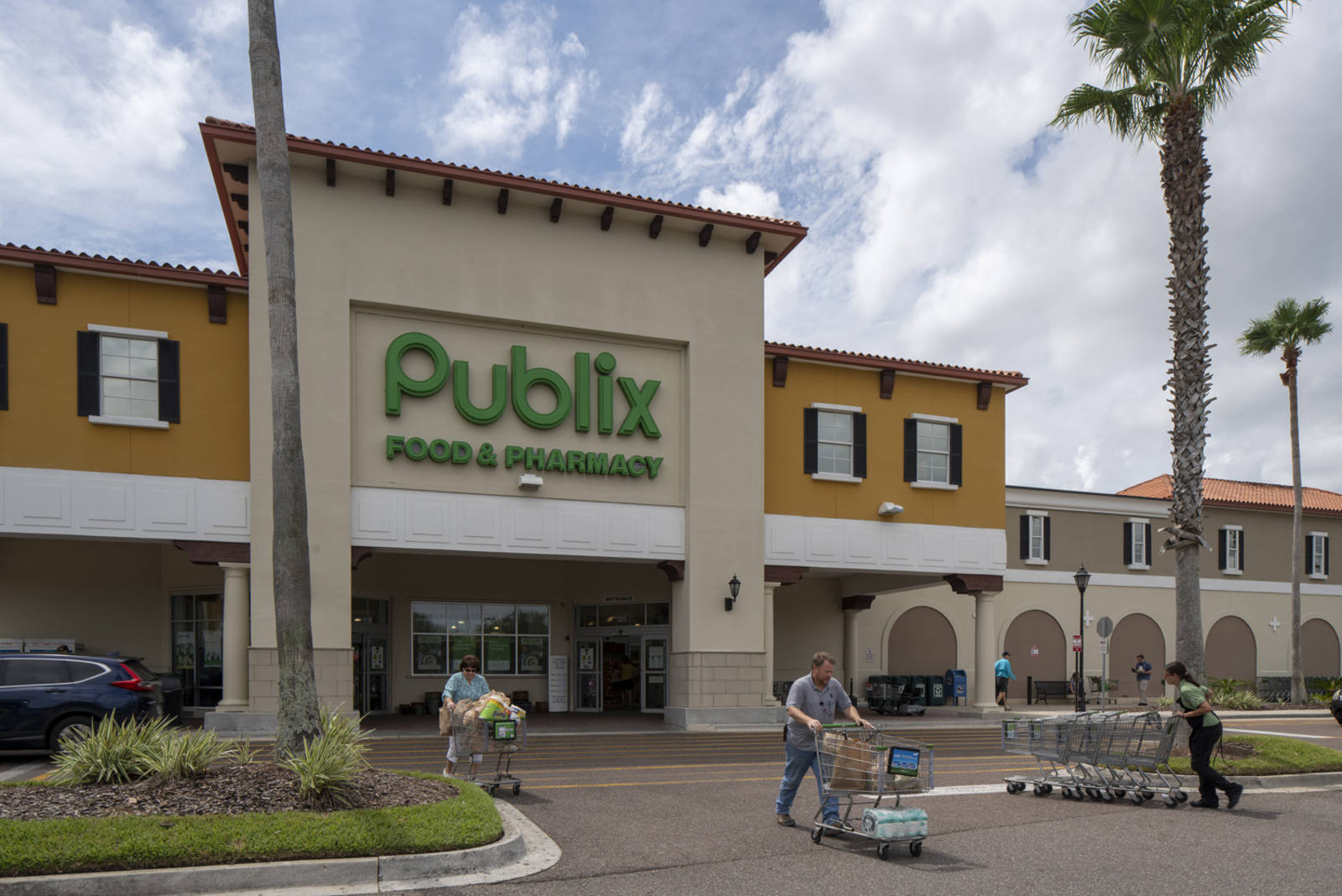 Shoppers with carts exit Publix supermarket in St. Augustine, FL.