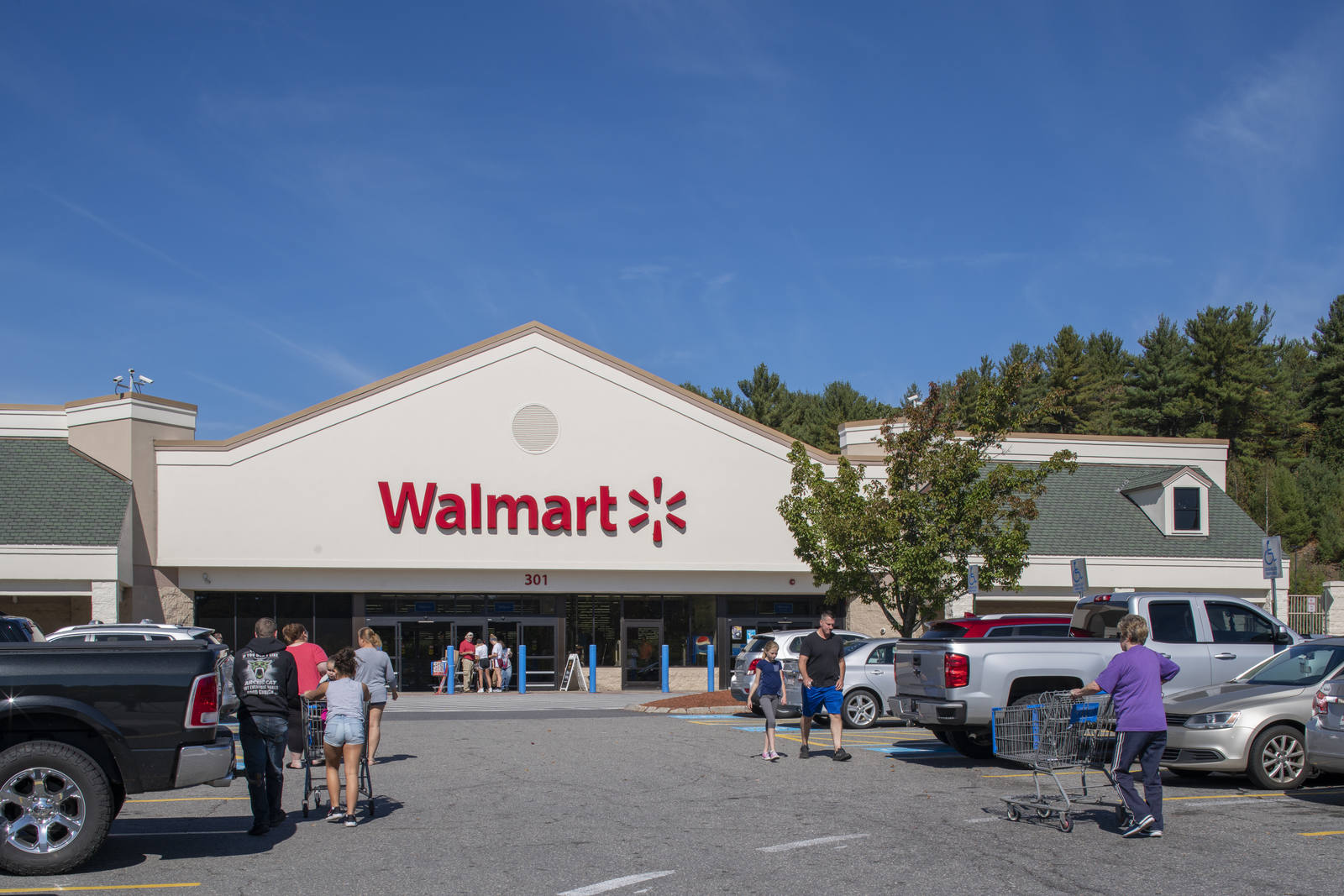Customers with carts enter and exit Walmart at Lunenburg Crossing.