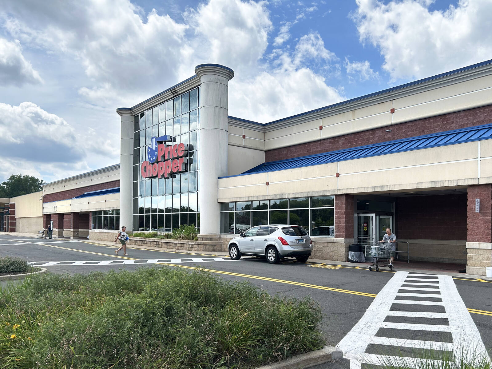 Customers enter and exit Price Shopper in Newington, CT.