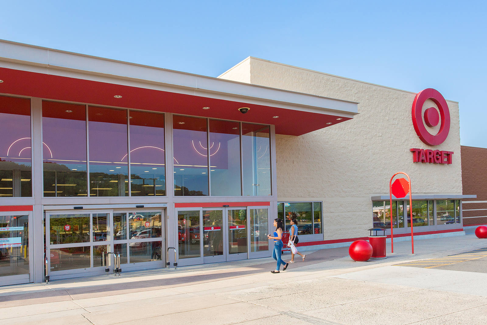 Two people walking into entrance of Target