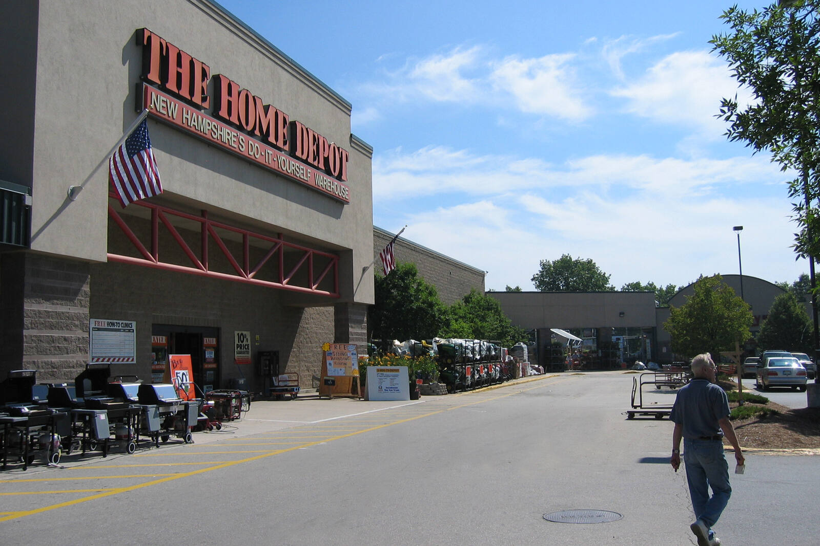 Parking lot and customer at The Home Depot hardware store in Nashua, NH.