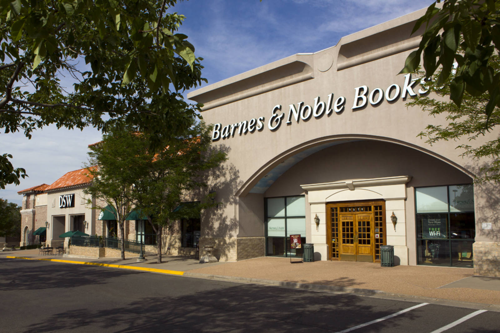 Tree branches hanging over the entrance of Barnes & Noble 
