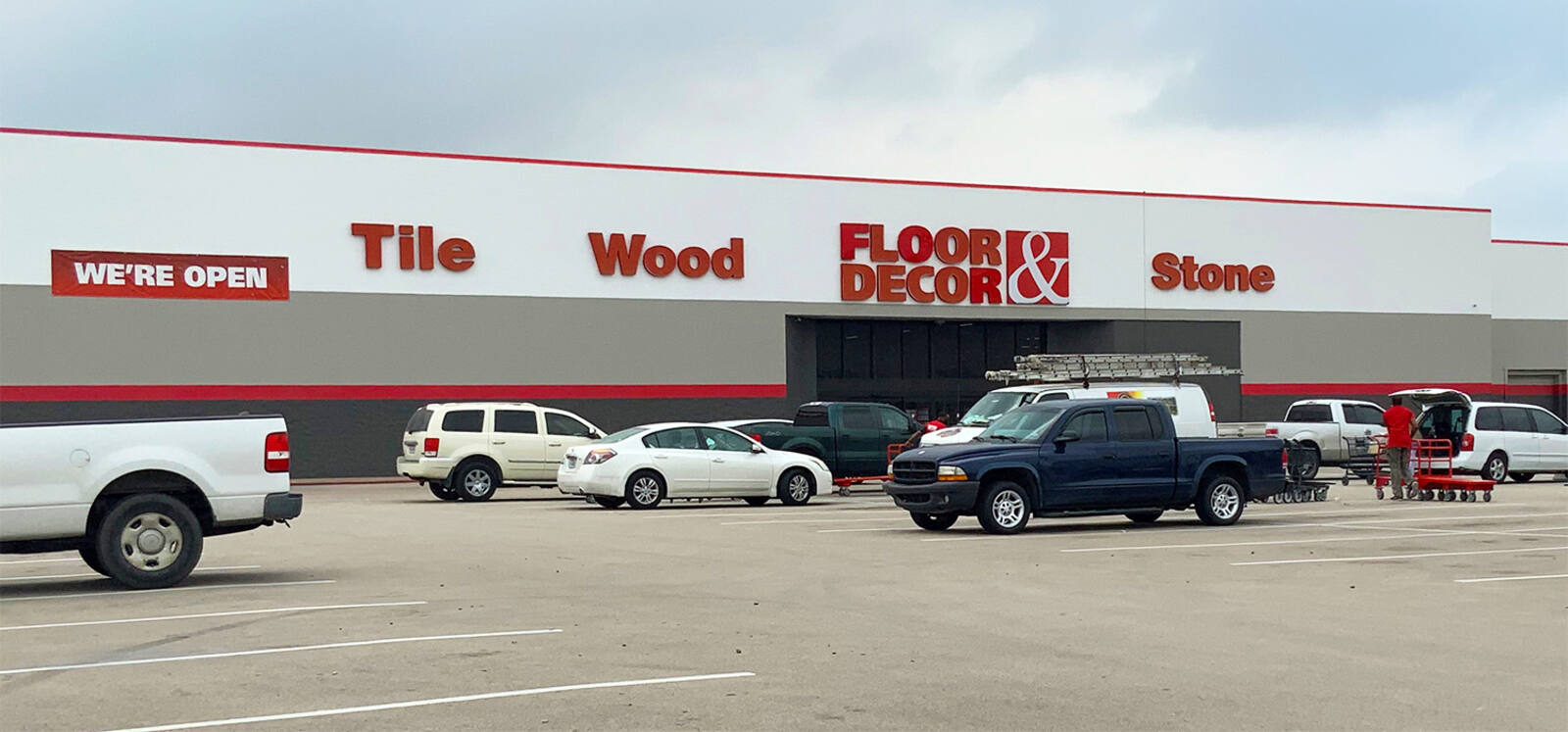 Cars sporadically parked in front of Floor & Decor at Orange Grove Shopping Center
