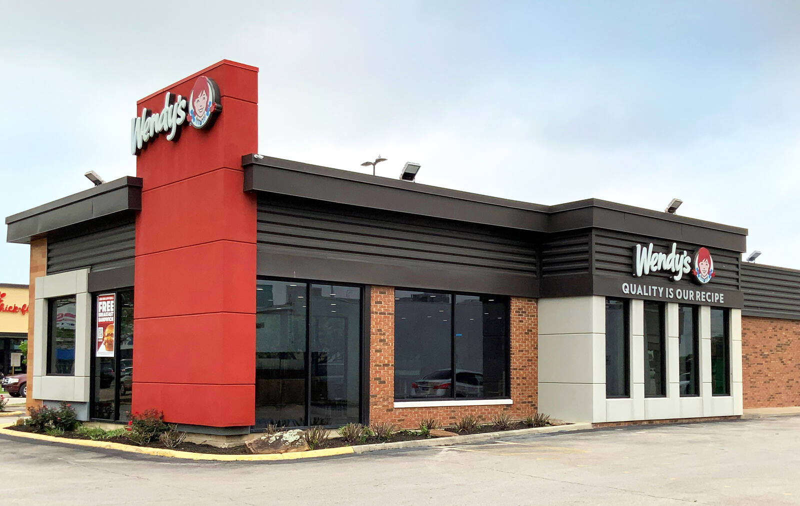 Front exterior of Wendy's at outdoor shopping center in Houston, Texas