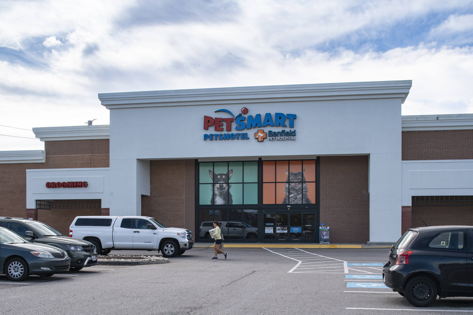 Pedestrian and cars in the lot of PetSmart at Hilltop Plaza.