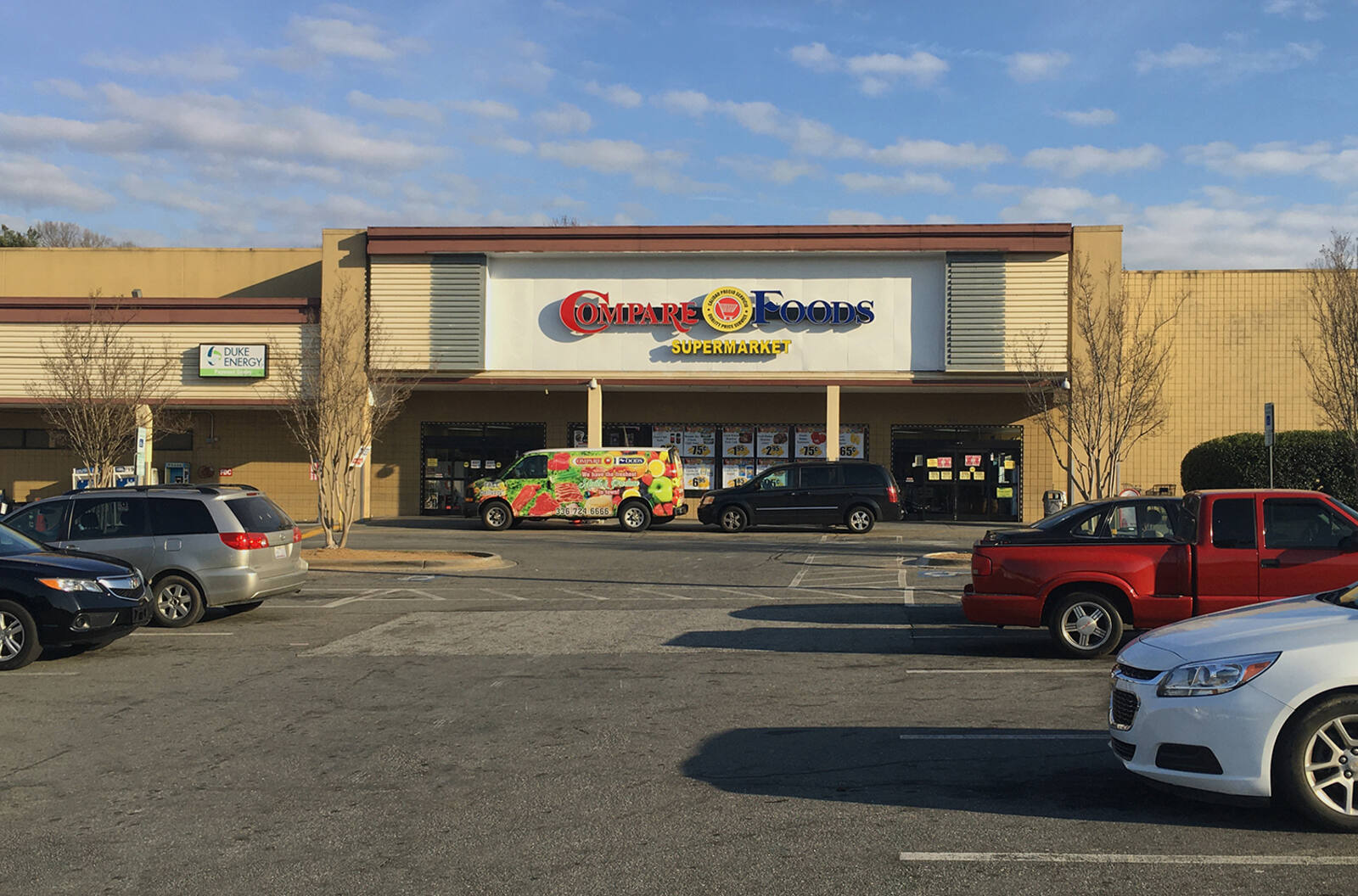 Car lined parking lot in front of Compare Foods at Parkway Plaza - Winston-Salem shopping center